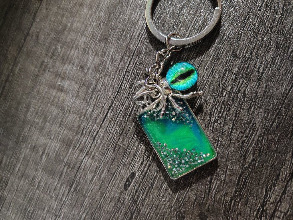 Veilwatcher™ — Emerald Spider Eye Glow Keychain