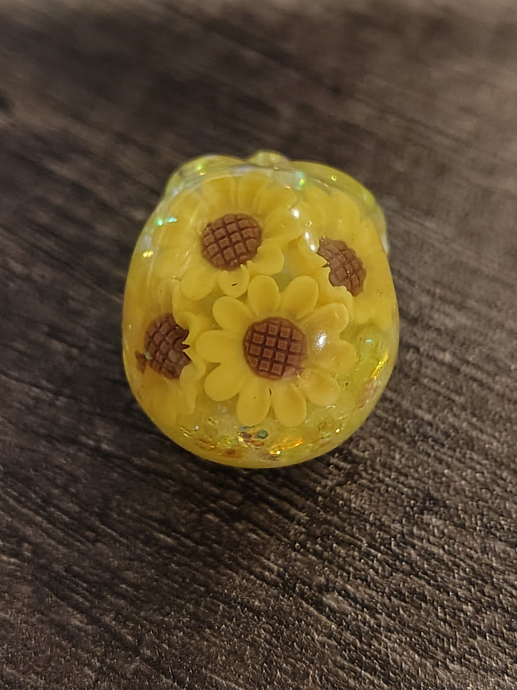 Yellow resin mini skull with sunflower charms - top view showing flower detail