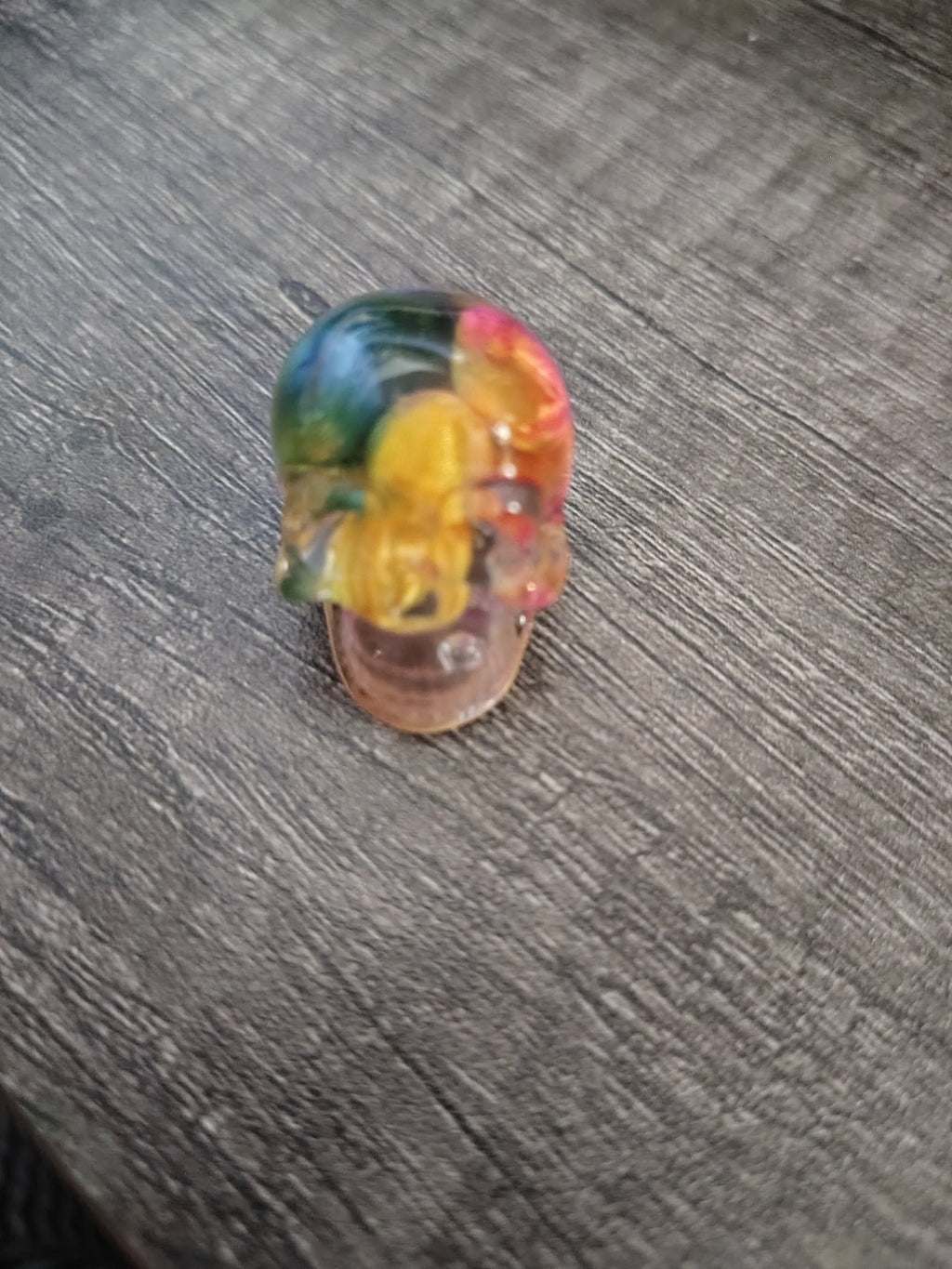 Clear rainbow resin mini skull filled with tiny 3D printed rubber duckies - front view