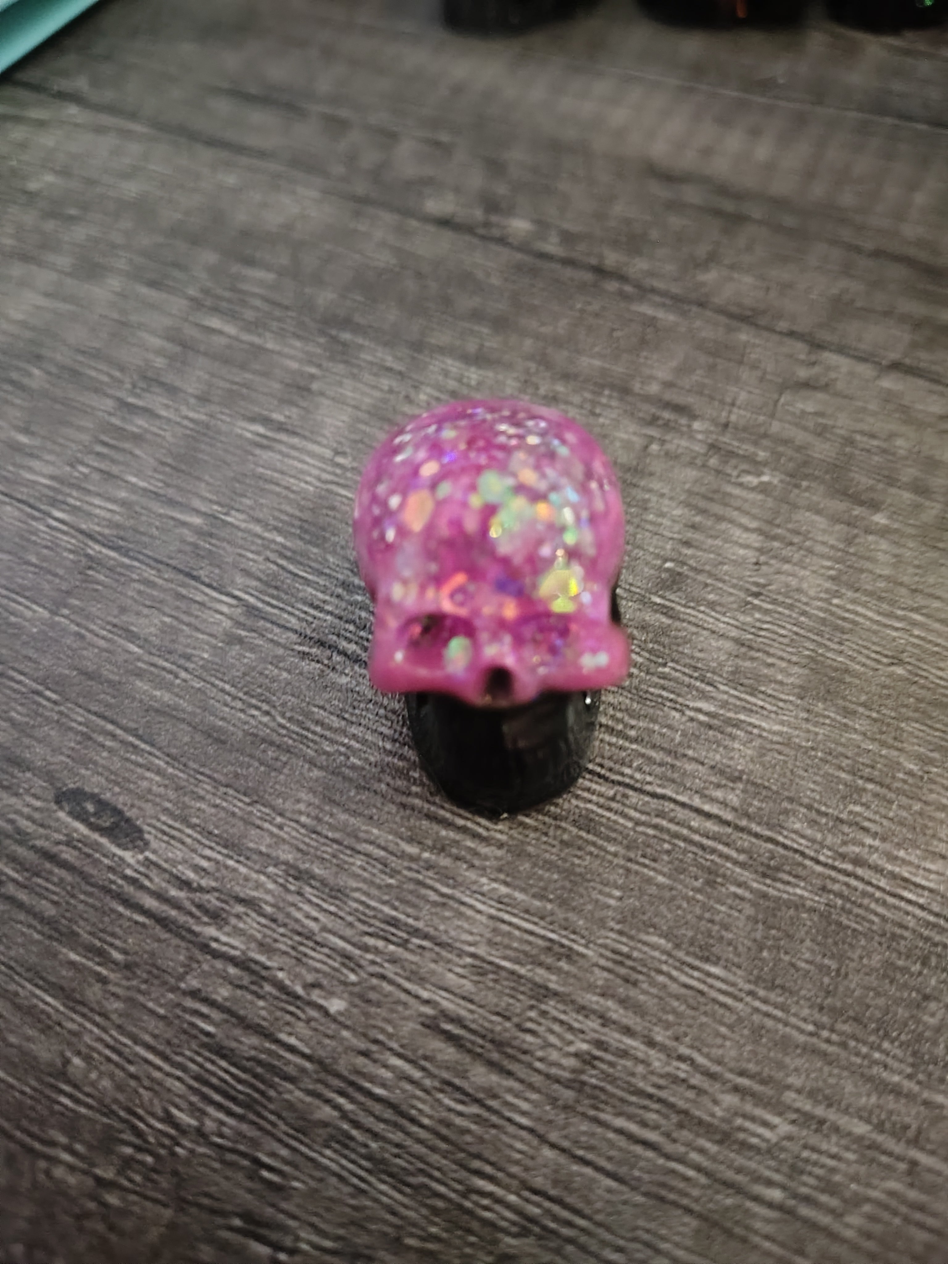 Pink feather holographic glitter mini skull with black jaw - front view