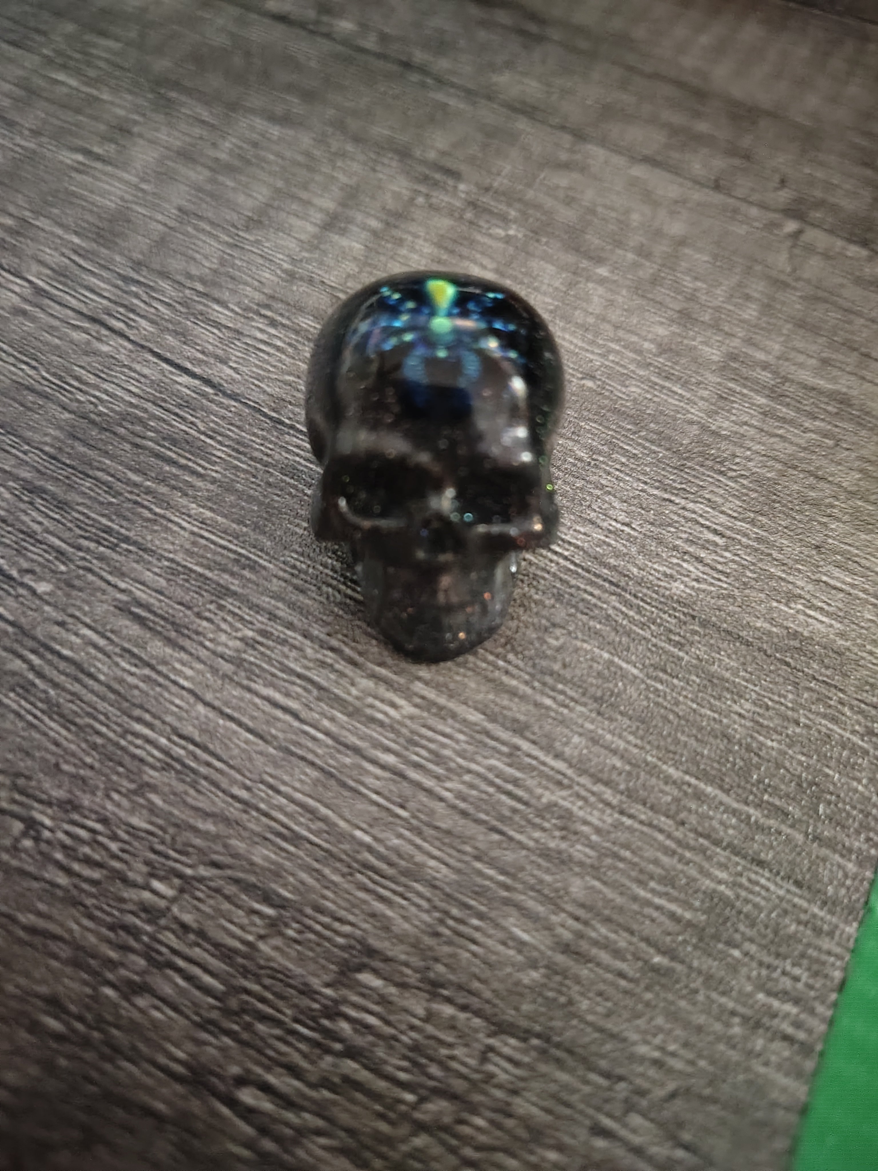 Black iridescent glitter mini skull with green shimmer spider - front view
