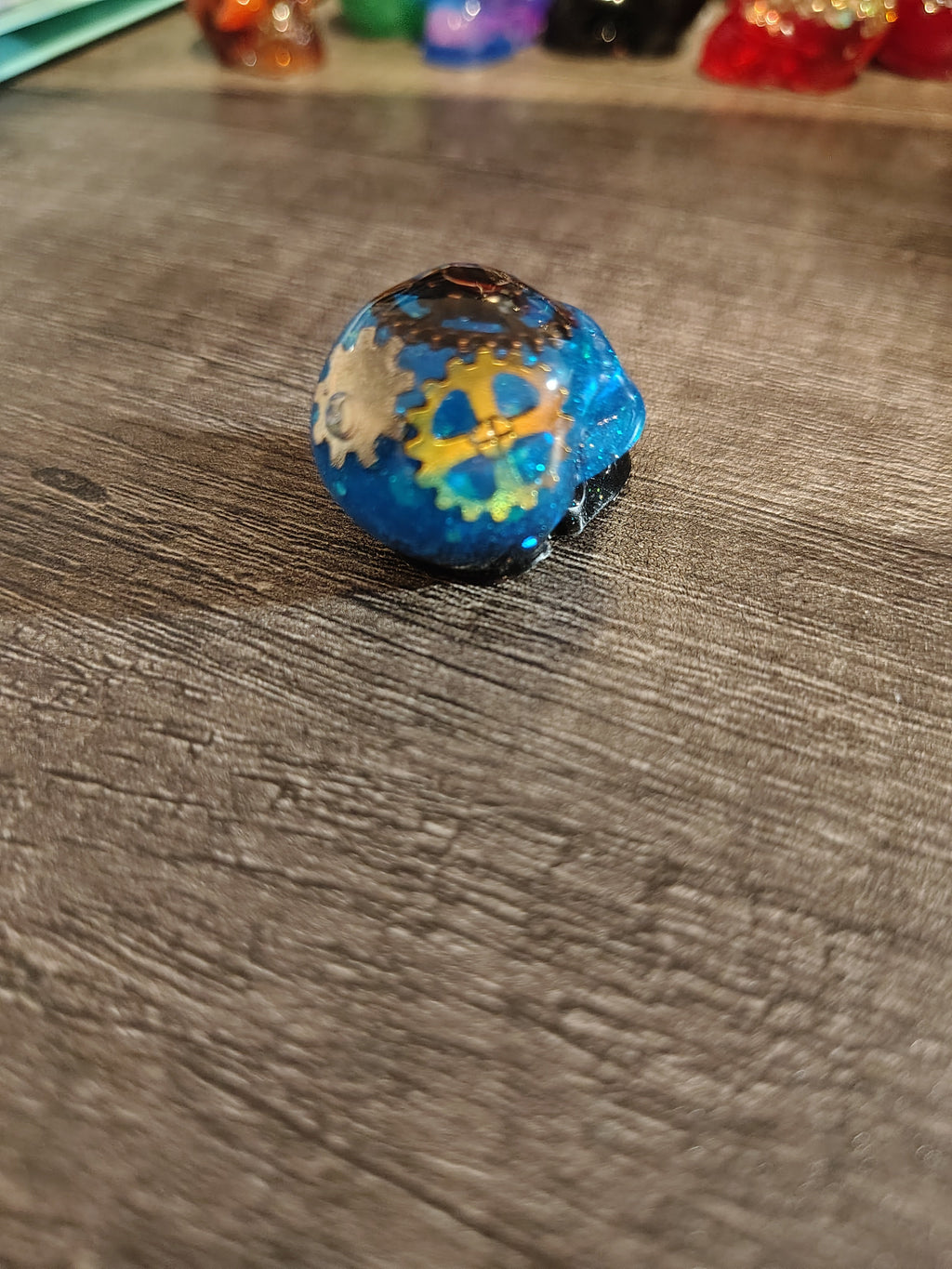 Electric blue steampunk mini skull with gold and silver gears - back view