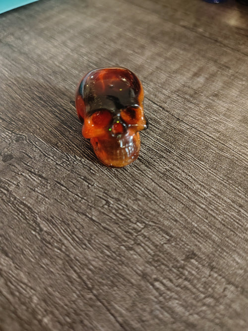 Amber orange and black swirl mini resin skull - front view