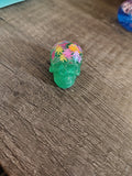 Green glitter mini skull with colorful maple leaf confetti crown - side view