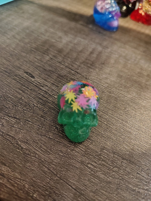 Green glitter mini skull with colorful maple leaf confetti - front view