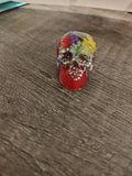 Red resin mini skull with real pressed flowers and silver crushed glitter - front view