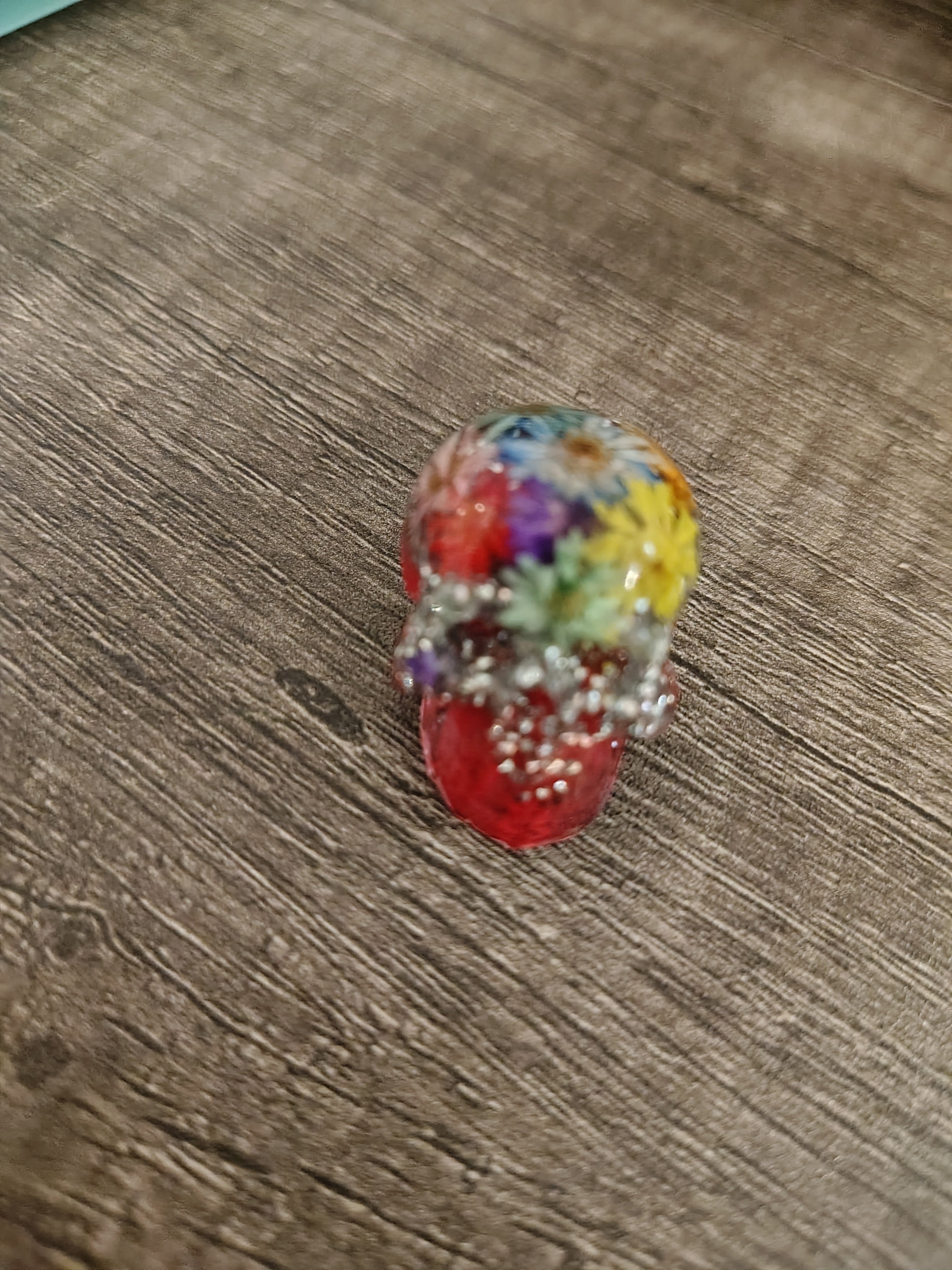 Red resin mini skull with pressed botanicals and silver glitter - side view