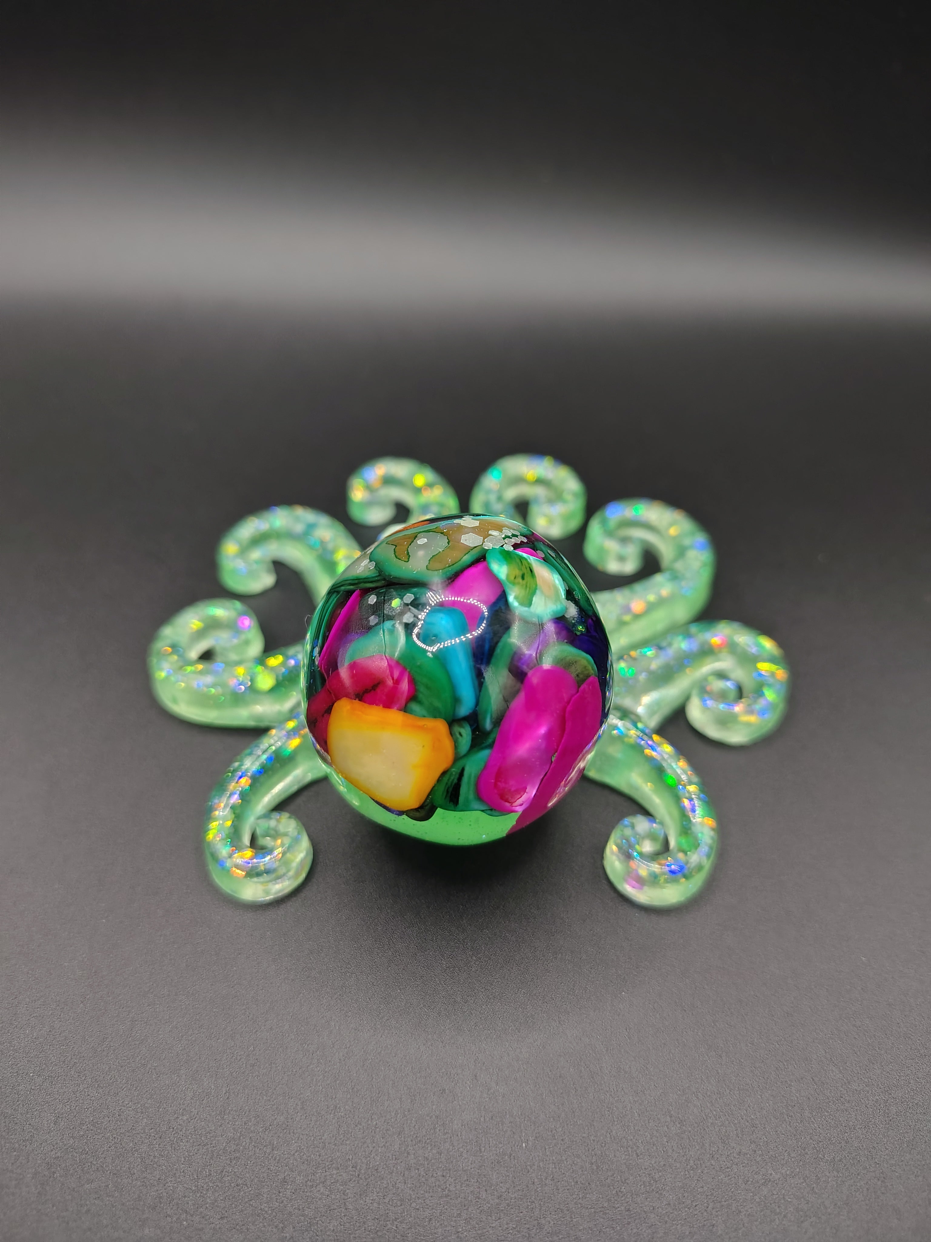 OctoPals™ - green glitter octopus with rainbow inclusions angled view