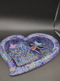 Heart-shaped purple holographic glitter resin tray with butterfly, moon, and star tiles