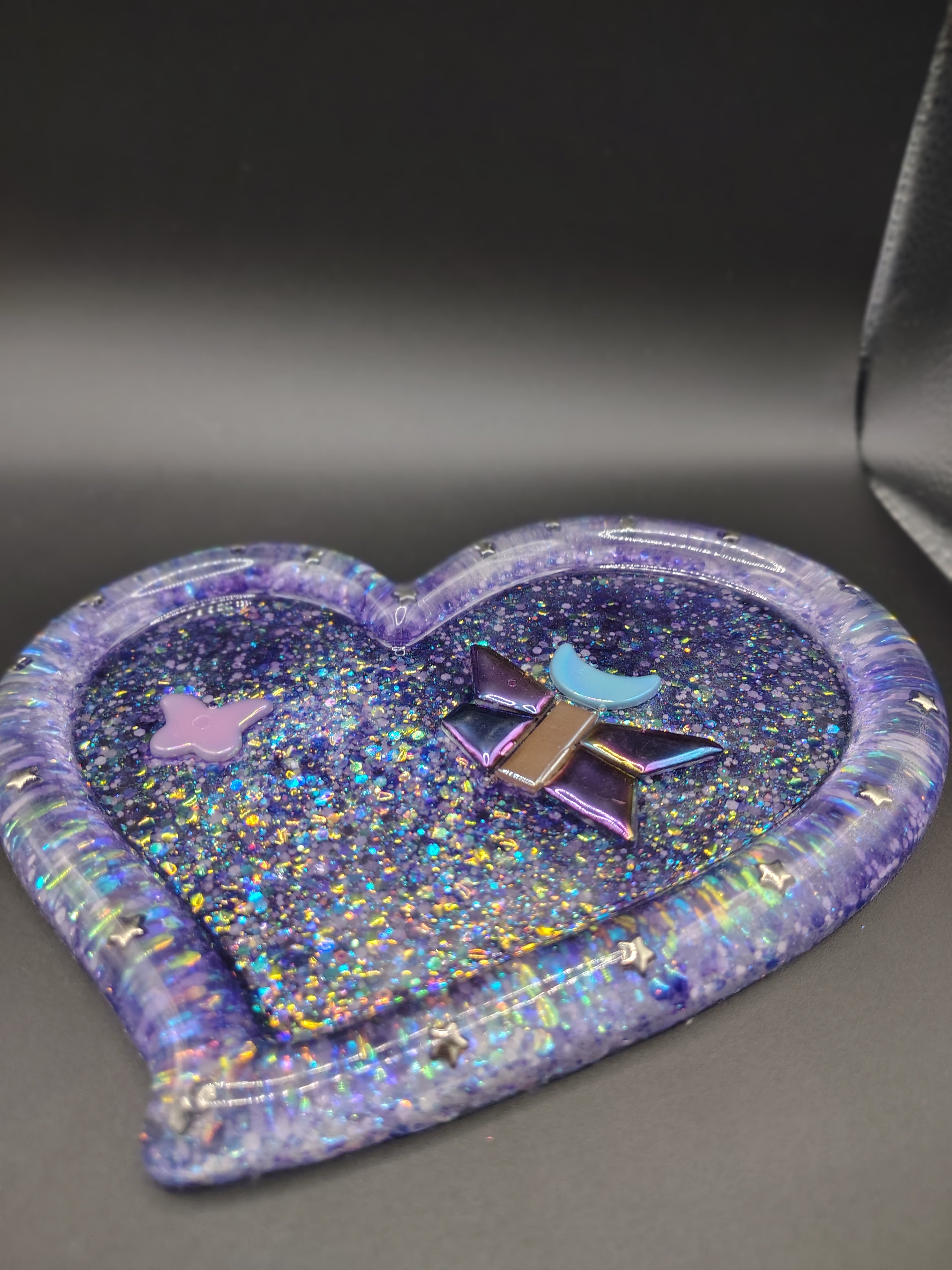 Heart-shaped purple holographic glitter resin tray with butterfly, moon, and star tiles