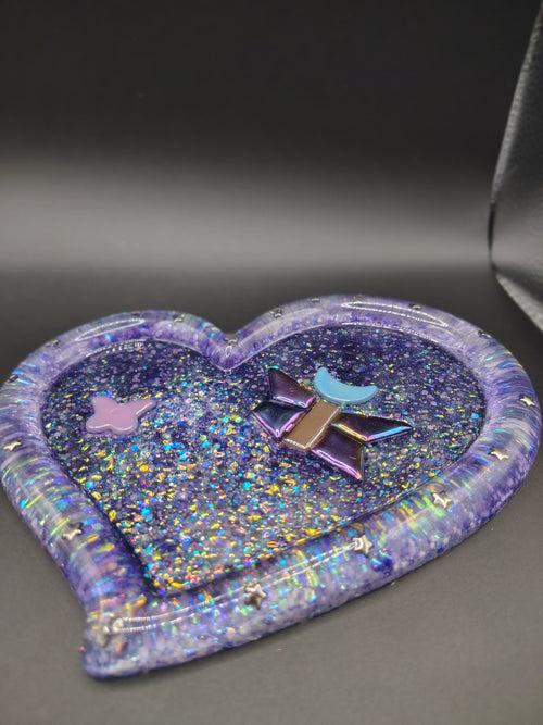 Heart-shaped purple holographic glitter resin tray with butterfly, moon, and star tiles