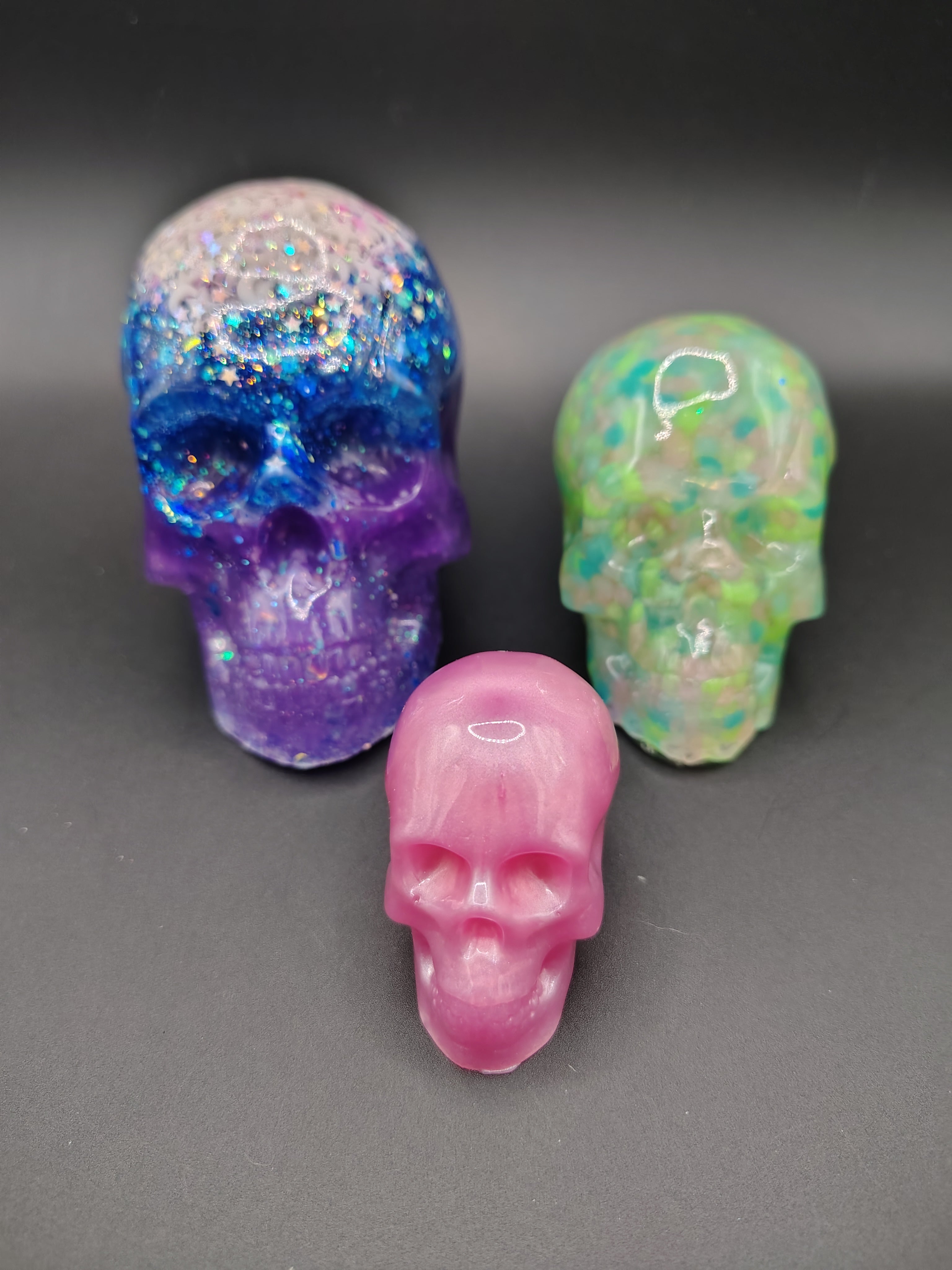 Size comparison showing medium Loomlight skull alongside large and small HeadCase skulls