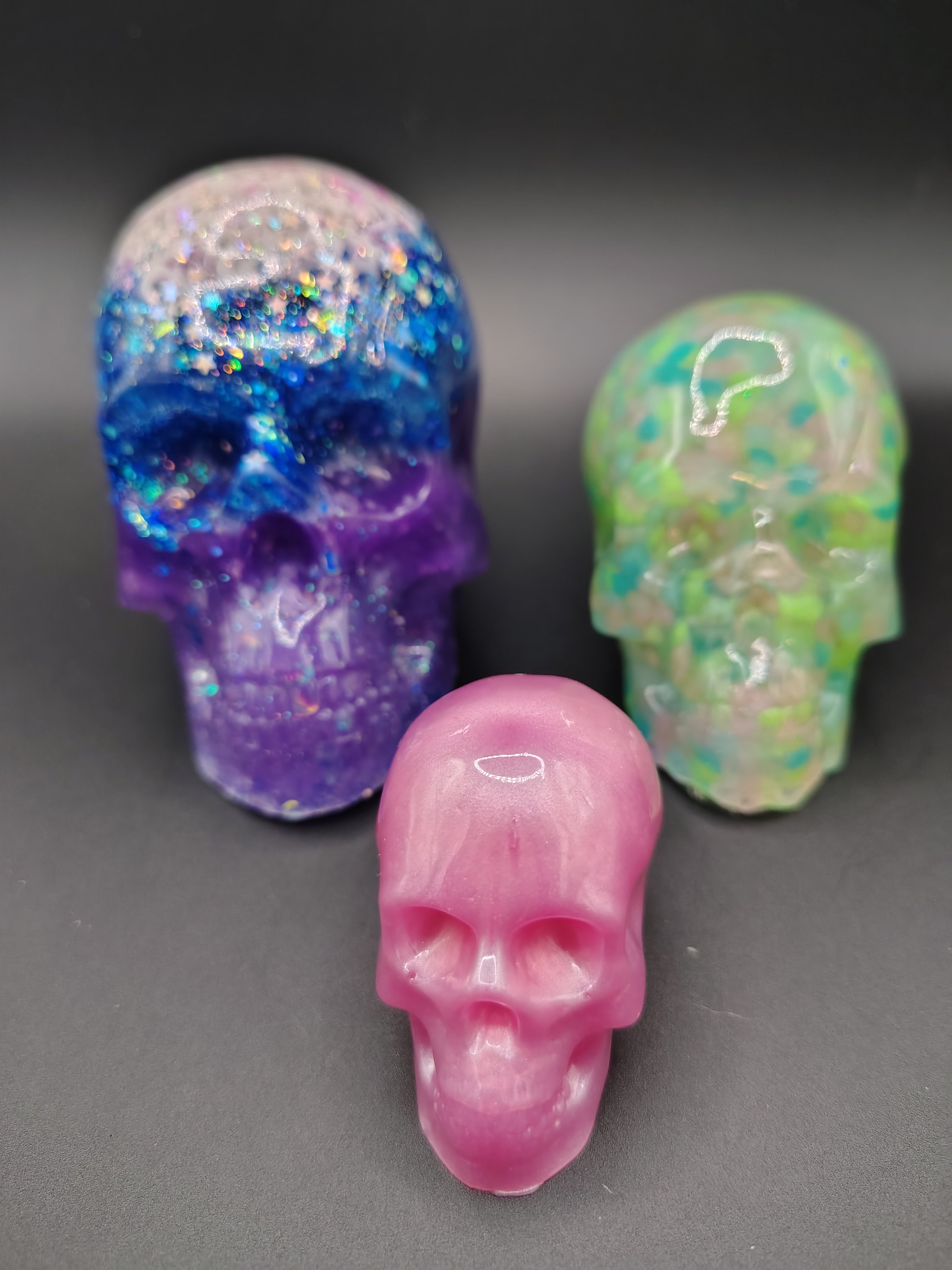 Size comparison showing large galaxy skull alongside medium and small HeadCase skulls