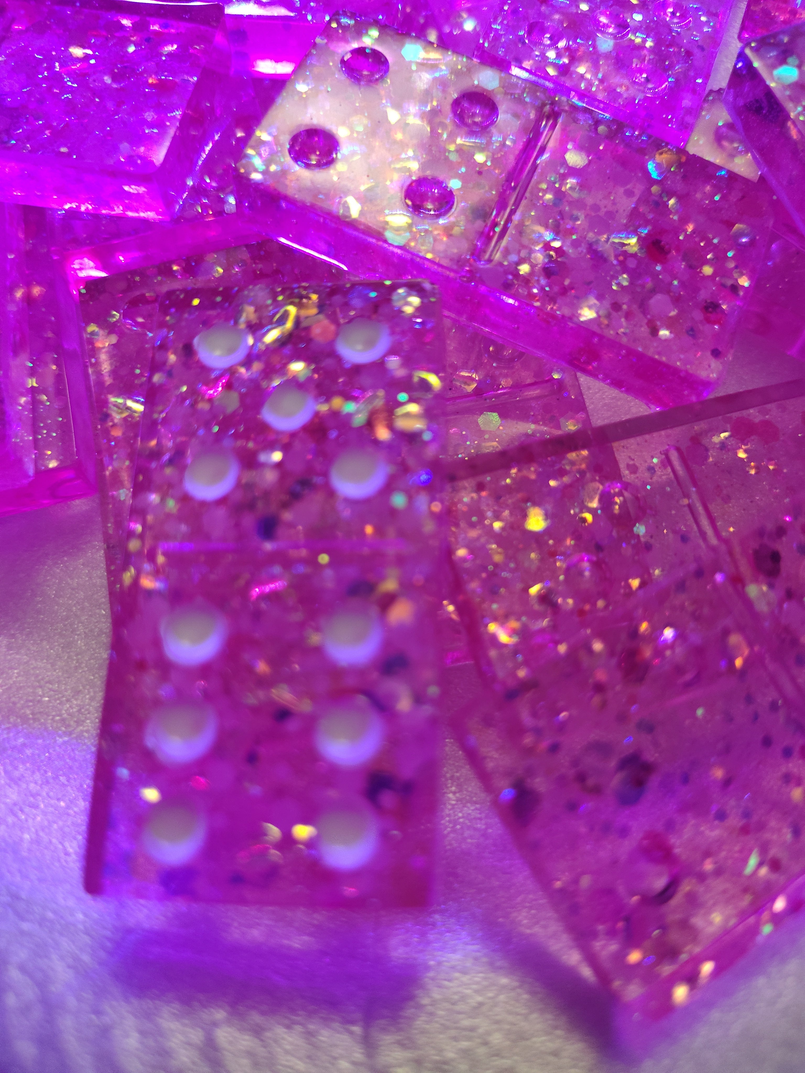 Pink resin dominoes close up